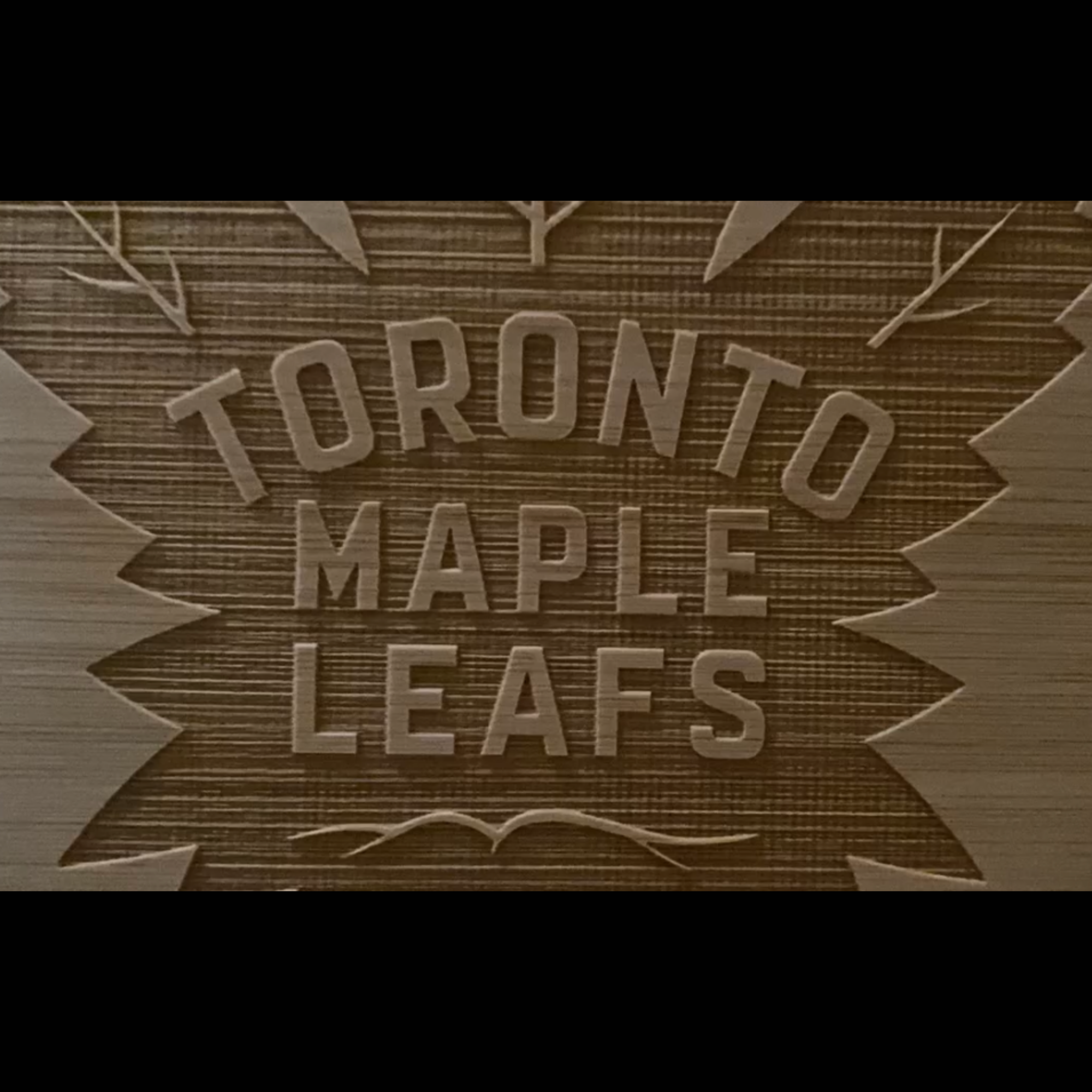Wooden plaque with 'Toronto Maple Leafs' engraved on it