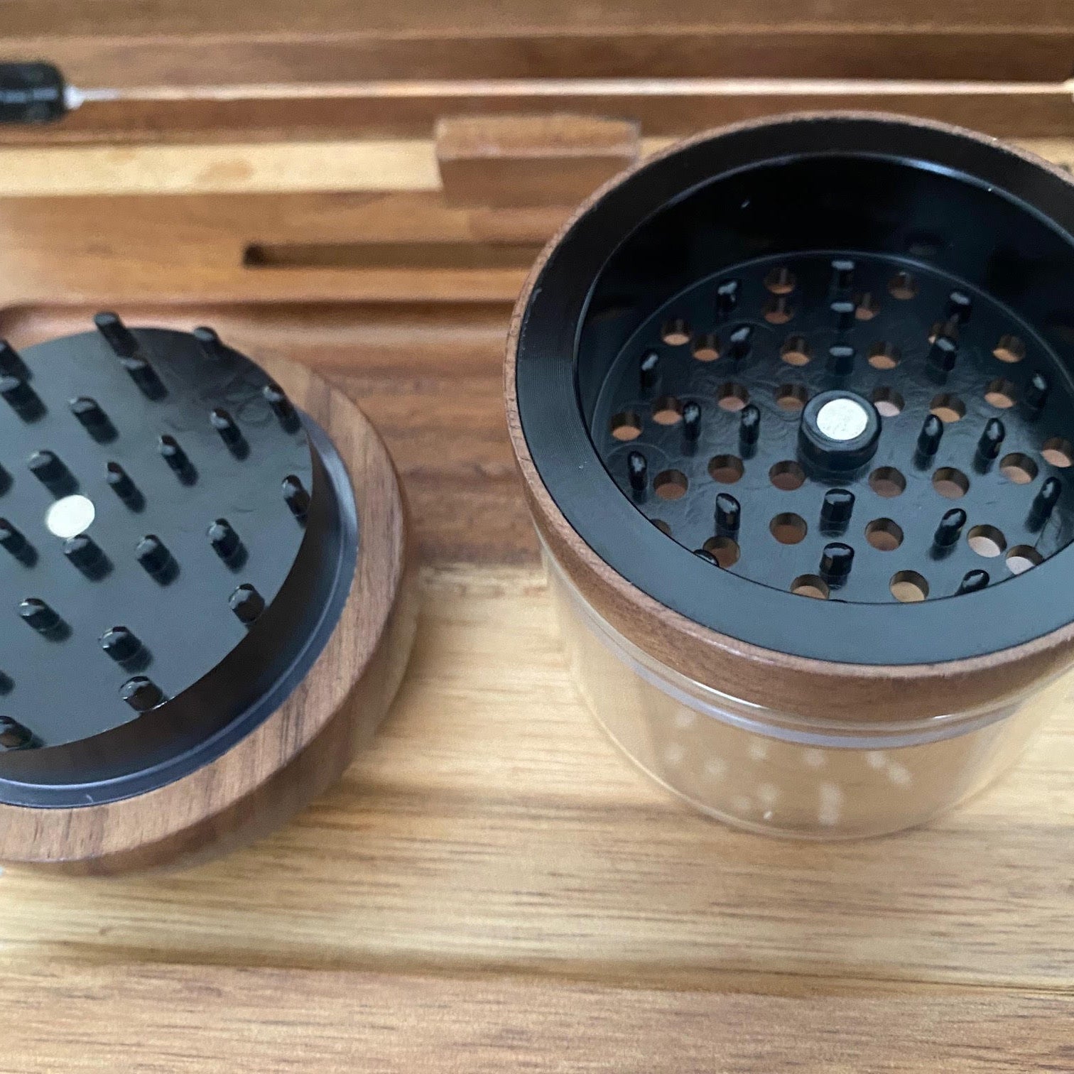 Wooden and metal grinder on a wooden surface