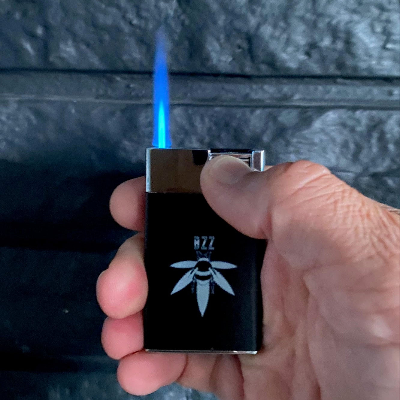 refillable butane lighter with the Bzz Box logo.